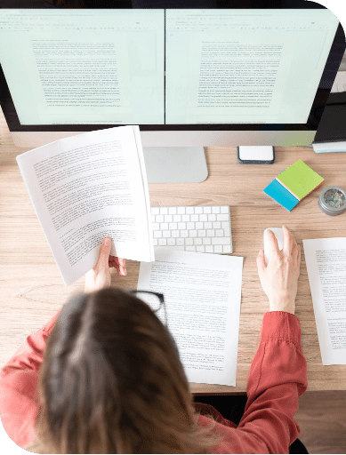 An editor working both by hand and digitally.