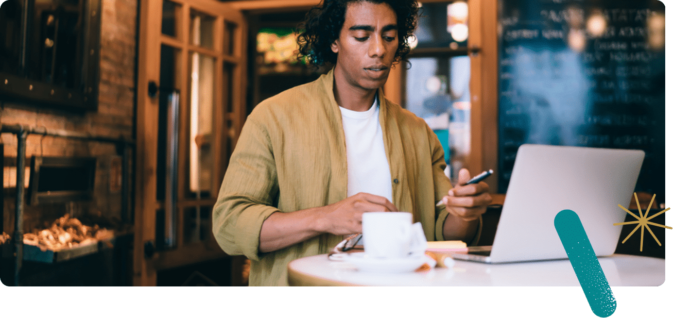 Young man on a laptop in a cafe
