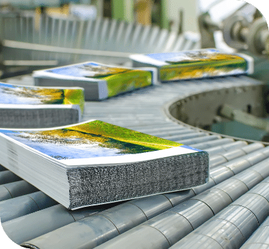 A book proceeding down a printing belt.